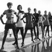 Models wearing Pierre Cardin two-tone jersey dresses, with vinyl waders
