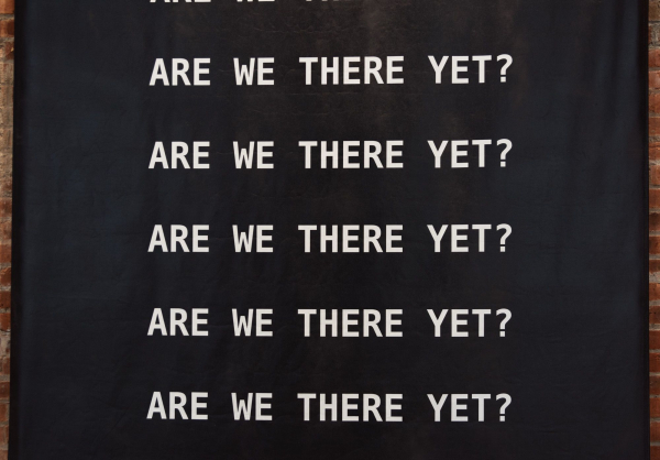 Kameelah Janan Rasheed: Installation detail of A QUESTION IS A SENTENCE DESIGNED TO ELICIT A RESPONSE. TODAY, WE WANT TO KNOW WHAT THE SLOPPY FUTURE HOLDS. Banner detail has the words Are We There Yet?