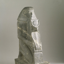 <p><em>Kneeling Statue of Senenmut</em>. Egypt, from Armant. New Kingdom, Dynasty 18, joint reign of Hatshepsut and Thutmose III, 1478–1458 <small>B.C.E.</small> Granite, 18<sup>9</sup>⁄<sub>16</sub> x 6<sup>7</sup>⁄<sub>8</sub> in. (47.2 × 17.4 cm), base: 6<sup>3</sup>⁄<sub>4</sub> x 2<sup>15</sup>⁄<sub>16 </sub>x 11<sup>9</sup>⁄<sub>16</sub> in. (17.2 × 7.5 × 29.3 cm). Brooklyn Museum, Charles Edwin Wilbour Fund, 67.68</p>