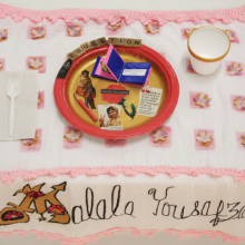 <p>Tracie. <i>Malala Yousafzai Place Setting</i>, from the series <i>Shared Dining</i>, by Women of York, 2015. Courtesy of Susan Meiselas/Three Guineas Fund Project. Photo: © Susan Meiselas</p>