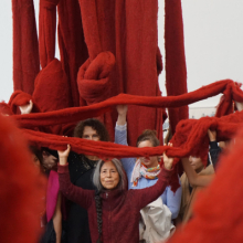 <p>Cecilia Vicuña and visitors with <em>Quipu Gut</em> (installation at Documenta 14, Kassel, Germany), 2017. Mixed media, unspun dyed wool, dimensions variable. Collection of Lehmann Maupin, New York, New York. © Cecilia Vicuña. Courtesy of the artist and Lehmann Maupin, New York and Hong Kong</p>