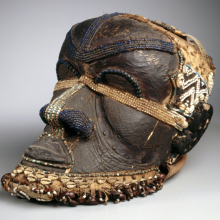 <p>Kuba artist. <em>Bwoom Mask</em>, late 19th or early 20th century. West Kasai Province, Democratic Republic of the Congo. Wood, copper alloy, plant fiber, skin, cowrie shells, seedpods, glass beads, textile, pigments, 13<sup>3</sup>/<sub>4</sub> x 8<sup>1</sup>/<sub>4</sub> x 12 in. (35 x 21 x 30.5 cm). Gift of Mr. and Mrs. John McDonald, 73.178. (Photo: Brooklyn Museum)</p>