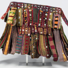 
                           
                           Yorùbá artist. Egúngún Masquerade Dance Costume (paka egúngún), circa 1920–48. Lekewọgbẹ compound, Ògbómọ̀ṣọ́, Ọ̀yọ́ State, Nigeria. Cotton, wool, wood, silk, synthetic textiles (including viscose rayon and acetate), indigo dye, and aluminum, 58 x 7 x 70 in. (147.32 x 17.78 x 177.8 cm). Brooklyn Museum; Gift of Sam Hilu, 1998.125. (Photo: Brooklyn Museum)
                           
                           
