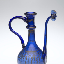 <p>Ewer, Iran, (Qum), Qajar period, 19th century. Glass; free-blown, applied, pinched, gilded; tooled on the pontil, 10 1/4 × 7 1/2 × 4 5/16 in. (26 × 19 × 11 cm). Brooklyn Museum, Henry L. Batterman Fund, 47.203.19. (Photo: Brooklyn Museum)</p>