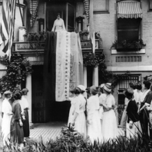 Unknown photographer: Alice Paul Unfurls the Ratification Flag at National Woman’s Party Headquarters in Celebration When Tennessee Became the 36th State to Ratify the Federal Suffrage Amendment