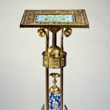 <p>Bradley & Hubbard Manufacturing Company (active 1854–1940). <i>Stand</i>, circa 1885, Meriden, Connecticut. Brass, glazed earthenware, 32<sup>13</sup>⁄<sub>16</sub> x 13<sup>3</sup>⁄<sub>8</sub> x 13<sup>3</sup>⁄<sub>8</sub> in. (83.3 × 34.0 × 34.0 cm). Brooklyn Museum, Gift of the American Art Council, 1998.45</p>