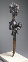 <p><em>Mother with Child (Lupingu Iwa Cibola)</em>. Unidentified Lulua artist, 19th century. West Kasai province, Democratic Republic of the Congo. Wood, copper alloy, palm oil, camwood paste, organic materials, 14 × 3<sup>3</sup>⁄<sub>8</sub> x 3<sup>1</sup>⁄<sub>2</sub> in. (35.6 × 8.6 × 8.9 cm). Museum Collection Fund, 50.124</p>