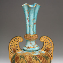 <p>Edward Lycett (American, b. England, 1833–1910). Faience Manufacturing Company (1881–92). <i>Vase</i>, 1886–90. Cream-colored earthenware with mottled blue, black, and maroon glazed ground with flat and raised gold paste decoration and enamel jewels. Collection of Andrew Van Styn</p>