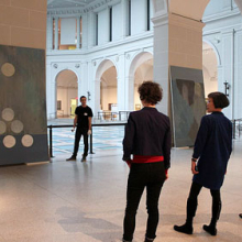 <p>Shura Chernozatonskaya and curator Eugenie Tsai work with Museum staff to install <i>Russian Modern</i>, one of a pair of paintings that responds to the “Russian Modern” section of the installation <i>European Paintings</i>, in the Beaux-Arts Court</p>