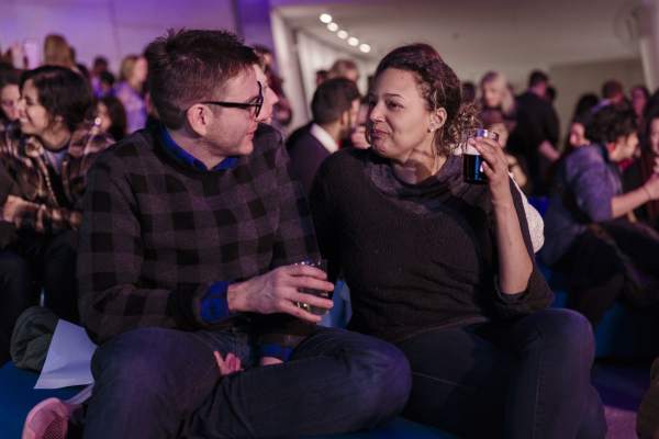 Two visitors share drinks and conversation at Art History Happy Hour