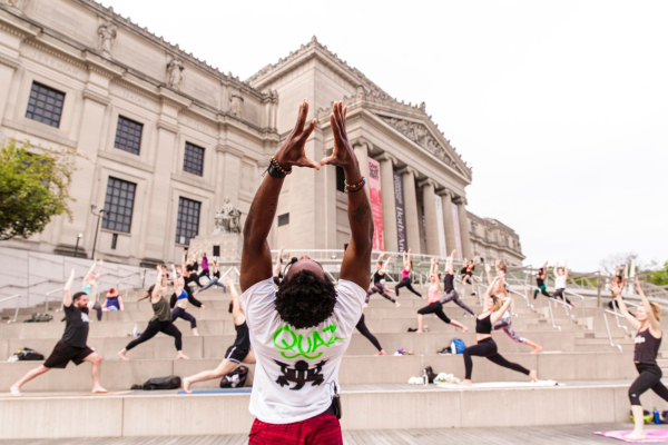 Participants practice yoga at Outdoor Yoga on the Stoop, 2021