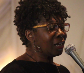 Close-up image of musician Patsy Grant singing into a microphone