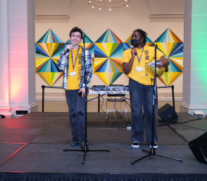 Two teens at microphones