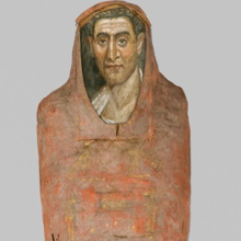 <p><i>Mummy of Demetrios</i>. Egypt, from Hawara. Roman Period. 95−100 <small>C.E.</small> Painted cloth, gold, human remains, wood, encaustic, gilding, 13<sup>3</sup>⁄<sub>8</sub> x 15<sup>3</sup>⁄<sub>8</sub> x 74<sup>13</sup>⁄<sub>16</sub> in (34 × 39 × 190 cm), portrait: 14 11/16 × 8 1/16 × 1/16 in. (37.3 × 20.5 × 0.2 cm). Brooklyn Museum, Charles Edwin Wilbour Fund, 11.600a−b</p>
