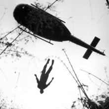 <p>Henri Huet (French, 1927–1971). <em>The body of an American paratrooper killed in action in the jungle near the Cambodian border is raised up to an evacuation helicopter, Vietnam</em>, 1966. Gelatin silver print (printed 2004), 14 × 10<sup>7</sup>⁄<sub>8</sub> in. (35.6 × 27.7 cm). The Museum of Fine Arts, Houston, museum purchase. © Associated Press</p>