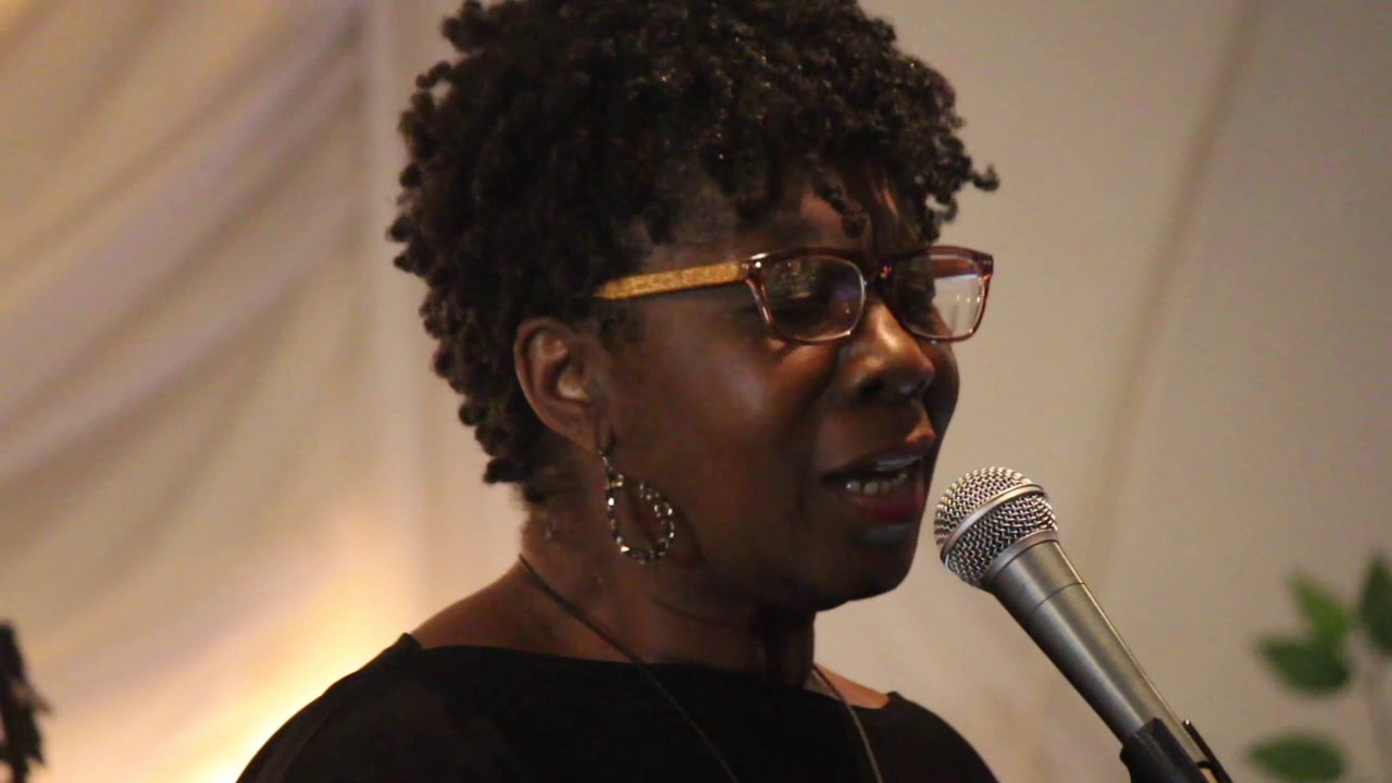 Close-up image of musician Patsy Grant singing into a microphone