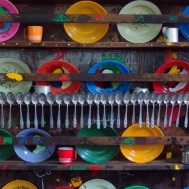 <p>Marcel Pinas (b. Suriname 1971). <em>Kuku (Kitchen)</em>, 2005. Plastic plates, aluminum spoons, cups, wood shelves; 59 × 59 × 8<sup>5</sup>⁄<sub>8</sub> in. (150 × 150 × 22 cm). Courtesy of the artist</p>
