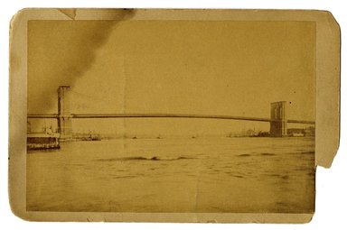 <em>"Brooklyn Bridge, view from river"</em>. Printed material. Brooklyn Museum. (F129_B79_C68_Pictures_of_Brooklyn_Brooklyn_Bridge_view_from_river.jpg