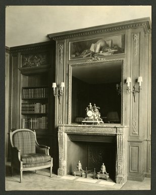 <em>"Weil-Worgelt apartment; upholstered chair and fireplace in French eighteenth-century revival style."</em>. Bw photographic print, 5 x 7 in (13 x 16 cm). Brooklyn Museum, CHART_2011. (NK2004_W42_Weil_Worgelt_apartment_page05.jpg