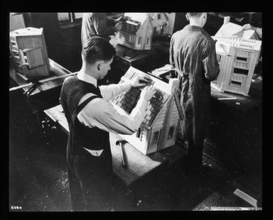 <em>"Views: Brooklyn, Long Island, Staten Island. Brooklyn scenes; buildings. View 002: Boys working on houses in the high school building construction class."</em>. Lantern slide 3.25x4in, 3.25 x 4 in. Brooklyn Museum, CHART_2011. (S10_11_Brooklyn_LI_SI_Brooklyn_Scenes_Buildings002.jpg