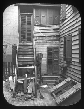 <em>"Views: Brooklyn. Various. View 025: Tenement House in Front Street. 1900."</em>, 1900. Lantern slide 3.25x4in, 3.25 x 4 in. Brooklyn Museum, CHART_2011. (Photo: Julius Wilcox, S10_12_Brooklyn_Various025.jpg