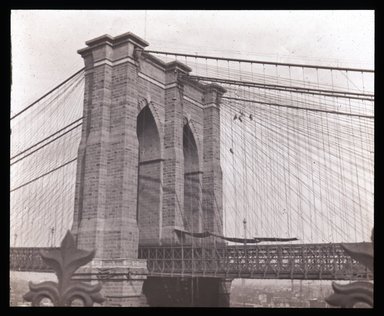 <em>"Views: U.S., Brooklyn. Brooklyn Bridge. View 005: Brooklyn tower; cobweb and the flies' from Fulton Ferry House, Brooklyn."</em>. Lantern slide 3.25x4in, 3.25 x 4 in. Brooklyn Museum, CHART_2011. (S10_21_US_Brooklyn_Brooklyn_Bridge005.jpg