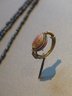 Cowrie-Shaped Amulet in Gold Ring