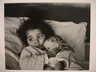 [Untitled] (Juanita Lying in Bed Hugging Doll)