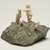 Inuit. <em>Scene: Two Men, a Child, and a Dog</em>, 1950-1980. Stone, ivory, 3 1/4 x 5 1/2 x 4 3/4 in. (8.3 x 14 x 12.1 cm). Brooklyn Museum, Hilda and Al Schein Collection, 2004.79.25. Creative Commons-BY (Photo: Brooklyn Museum, 2004.79.25_view02_PS11.jpg)