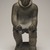Thomasi Kaitak (1912-1977). <em>Figure of a Man Bending Over</em>, 1950-1980. Gray stone, bone, 13 x 5 x 7 in. (33 x 12.7 x 17.8 cm). Brooklyn Museum, Hilda and Al Schein Collection, 2004.79.64. Creative Commons-BY (Photo: Brooklyn Museum, 2004.79.64_overall_PS11.jpg)