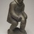 Thomasi Kaitak (1912-1977). <em>Figure of a Man Bending Over</em>, 1950-1980. Gray stone, bone, 13 x 5 x 7 in. (33 x 12.7 x 17.8 cm). Brooklyn Museum, Hilda and Al Schein Collection, 2004.79.64. Creative Commons-BY (Photo: Brooklyn Museum, 2004.79.64_threequarter_left_PS11-1.jpg)
