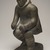 Thomasi Kaitak (1912-1977). <em>Figure of a Man Bending Over</em>, 1950-1980. Gray stone, bone, 13 x 5 x 7 in. (33 x 12.7 x 17.8 cm). Brooklyn Museum, Hilda and Al Schein Collection, 2004.79.64. Creative Commons-BY (Photo: Brooklyn Museum, 2004.79.64_threequarter_right_PS11.jpg)