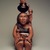 Roxanne Swentzell (Kah'p'oo Owinge (Santa Clara Pueblo), born 1962). <em>Making Babies for Indian Market</em>, 2004. Clay, pigment, 23 1/2 x 8 1/2 x 17 in. (59.7 x 21.6 x 43.2 cm). Brooklyn Museum, Gift in memory of Helen Thomas Kennedy, 2004.80. © artist or artist's estate (Photo: Brooklyn Museum, 2004.80_front.jpg)