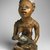 Yombe artist. <em>Figure of Mother and Child (Phemba)</em>, 19th century. Wood, glass, upholstery studs, metal, metal and glass buttons, resin, 11 x 5 x 4 1/2 in. (27.9 x 12.7 x 11.4 cm). Brooklyn Museum, Museum Expedition 1922, Robert B. Woodward Memorial Fund, 22.1138. Creative Commons-BY (Photo: Brooklyn Museum, 22.1138_SL1.jpg)