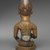 Yombe artist. <em>Figure of Mother and Child (Phemba)</em>, 19th century. Wood, glass, upholstery studs, metal, metal and glass buttons, resin, 11 x 5 x 4 1/2 in. (27.9 x 12.7 x 11.4 cm). Brooklyn Museum, Museum Expedition 1922, Robert B. Woodward Memorial Fund, 22.1138. Creative Commons-BY (Photo: Brooklyn Museum, 22.1138_back_PS2.jpg)