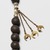  <em>Prayer Beads</em>, 19th century. Gilded copper, pearls, and tinted seeds, 29 1/2 in. (74.9 cm). Brooklyn Museum, Gift of Mrs. Lyman Underwood, 33.174. Creative Commons-BY (Photo: Brooklyn Museum, 33.174_detail03_PS11.jpg)