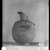  <em>Vase with Face of Bes on One Side</em>, 664-332 B.C.E. Clay, 4 13/16 x Diam. 2 3/8 in. (12.2 x 6 cm). Brooklyn Museum, Charles Edwin Wilbour Fund, 37.329E. Creative Commons-BY (Photo: Brooklyn Museum, 37.329E_NegC_SL4.jpg)