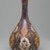  <em>Lobed Pear-Shaped Bottle with Floral Escutcheons</em>, 17th century. Ceramic; fritware, painted in cobalt blue and red (copper) and yellow (silver) luster on an opaque white glaze, 12 3/16 x 6 5/16 in. (31 x 16 cm). Brooklyn Museum, Gift of Mrs. Horace O. Havemeyer, 42.212.14. Creative Commons-BY (Photo: Brooklyn Museum, 42.212.14_side2_PS2.jpg)