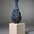  <em>Bottle with Openwork Shell</em>, ca. 1075-712 B.C.E. Egyptian blue, 6 11/16 x greatest diam. 2 15/16 in. (17 x 7.5 cm). Brooklyn Museum, Charles Edwin Wilbour Fund, 44.175. Creative Commons-BY (Photo: Brooklyn Museum, 44.175_SL1.jpg)