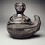 Chimú. <em>Effigy Vessel in Form of a Human Figure Emerging from a Gourd</em>, 17th or 18th century (possibly). Ceramic, 8 1/2 x 8 1/2 x 6 in. (21.6 x 21.6 x 15.2 cm). Brooklyn Museum, Gift of Florence Walker, 53.97.1. Creative Commons-BY (Photo: Brooklyn Museum, 53.97.1.jpg)