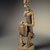 Dogon. <em>Figure of a Seated Musician (Koro Player)</em>, late 18th century. Wood, iron, 22 x 7 x 4 1/4 in. (55.8 x 17.7 x 10.8 cm). Brooklyn Museum, Frank L. Babbott Fund, 61.2. Creative Commons-BY (Photo: Brooklyn Museum, 61.2.jpg)