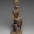 Dogon. <em>Figure of a Seated Musician (Koro Player)</em>, late 18th century. Wood, iron, 22 x 7 x 4 1/4 in. (55.8 x 17.7 x 10.8 cm). Brooklyn Museum, Frank L. Babbott Fund, 61.2. Creative Commons-BY (Photo: Brooklyn Museum, 61.2_threequarter_PS2.jpg)