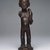 Chokwe. <em>Female Figure with Horn (Kaponya)</em>, late 19th century. Wood, copper alloy, 12 1/4 x 3 1/2 x 3 1/4 in. (31.1 x 8.9 x 8.3 cm). Brooklyn Museum, Gift of Marcia and John Friede, 74.89. Creative Commons-BY (Photo: Brooklyn Museum, 74.89_edited_version_SL1.jpg)