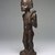 Chokwe. <em>Female Figure with Horn (Kaponya)</em>, late 19th century. Wood, copper alloy, 12 1/4 x 3 1/2 x 3 1/4 in. (31.1 x 8.9 x 8.3 cm). Brooklyn Museum, Gift of Marcia and John Friede, 74.89. Creative Commons-BY (Photo: Brooklyn Museum, 74.89_threequarter_edited_version_SL1.jpg)