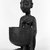 Yorùbá. <em>Kneeling Female Figure Holding a Bowl (Agere Ifa)</em>, late 19th or early 20th century. Wood, applied materials, (metal & beads in bag), h: 11 3/3 in. (30.0 cm). Brooklyn Museum, Gift of Ann W. Walzer, 80.245. Creative Commons-BY (Photo: Brooklyn Museum, 80.245_threequarter_bw.jpg)