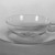 Wilhelm Wagenfeld (1900-1990). <em>Cup and Saucer</em>, 1930-1934. Clear heat-resistant glass, 1 3/8 x 5 1/8 x 3 7/8 in. (3.5 x 13 x 9.8 cm). Brooklyn Museum, Gift of Barry Friedman, 84.64.7a-b. Creative Commons-BY (Photo: Brooklyn Museum, 84.64.7a-b_bw.jpg)
