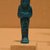  <em>Funerary Figurine of King Pinudjem I</em>, ca. 1025-1007 B.C.E. Faience, 4 5/16 × 1 3/8 × 1 in. (10.9 × 3.5 × 2.5 cm). Brooklyn Museum, Gift of Evangeline Wilbour Blashfield, Theodora Wilbour, and Victor Wilbour honoring the wishes of their mother, Charlotte Beebe Wilbour, as a memorial to their father, Charles Edwin Wilbour, 16.189. Creative Commons-BY (Photo: Brooklyn Museum, CUR.16.189_wwgA-3.jpg)