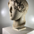 Roman. <em>Head, Apollo of the Omphalos</em>, 1st century C.E. copy of a 480 B.C.E. original. Marble, 12 5/8 × 7 7/8 × 9 1/16 in. (32 × 20 × 23 cm). Brooklyn Museum, Purchased with funds given by A. Augustus Healy and Robert B. Woodward Memorial Fund, 18.166. Creative Commons-BY (Photo: Brooklyn Museum, CUR.18.166_view03-1.jpg)