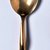 Izabel Lam. <em>Soup Spoon from a 5 Piece Place Setting, Sphere Pattern</em>, ca. 1990. Bronze, 5/8 x 1 3/4 x 8 in. (1.6 x 4.4 x 20.3 cm). Brooklyn Museum, Gift of Izabel Lam International, 1991.93.4. Creative Commons-BY (Photo: Brooklyn Museum, CUR.1991.93.4.jpg)