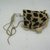 Mende. <em>Gbini Mask</em>, early 20th century. Wood, leopard skin, sheepskin, antelope skin, raffia fiber, raffia fiber twine, cotton cloth, cotton string, cowrie shells, Height: 17 in. (43.2 cm). Brooklyn Museum, Gift of William C. Siegmann, 2004.77a-d. Creative Commons-BY (Photo: Brooklyn Museum, CUR.2004.77c.jpg)